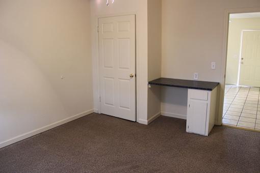 a room with a desk and a door