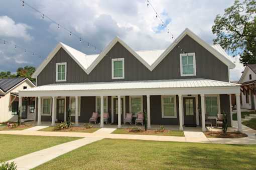 A house with a grey roof and white trim.