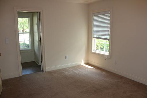 an empty room with a door and a window