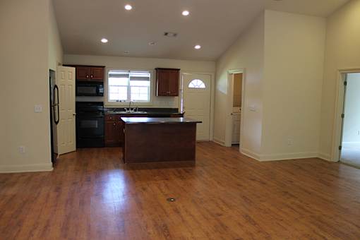 an empty kitchen with an island in the middle of it