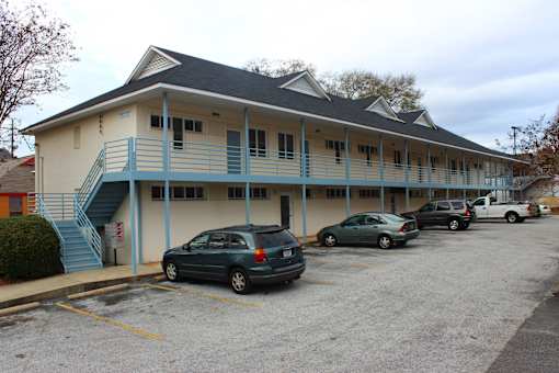 a large building with cars parked in front of it