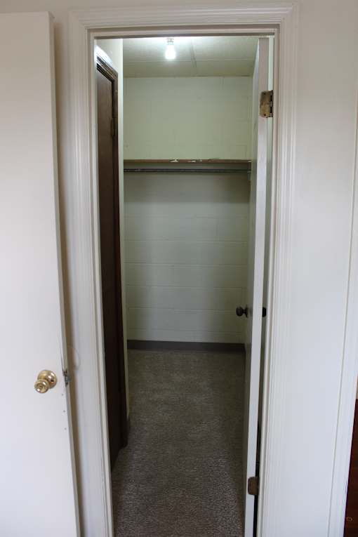 a mirror hanging on a wall above a window