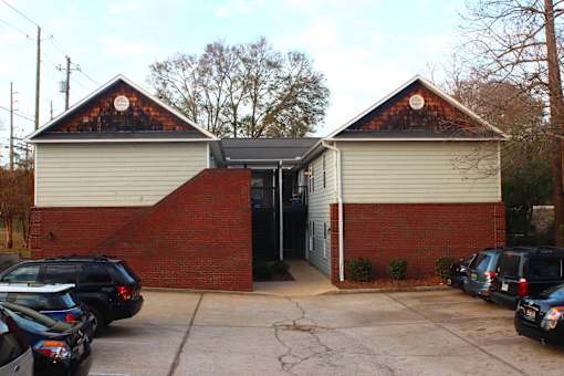 a small brick and with a parking lot