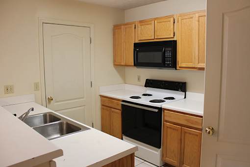a kitchen with a stove microwave and sink