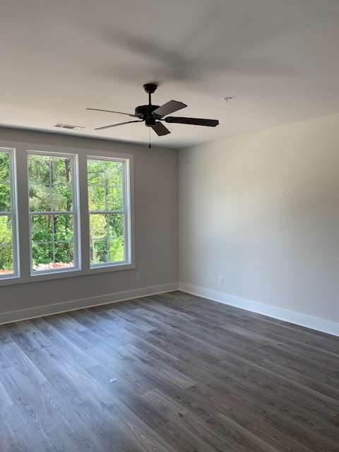 a ceiling fan and a window in a room