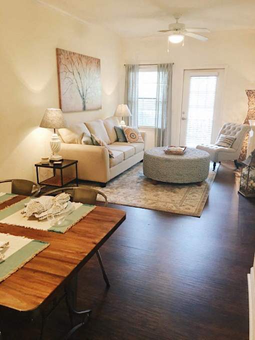 A living room with a couch, chair, and table.