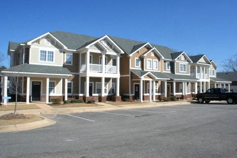 a row of houses on the side of a street