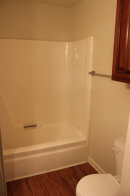 a small bathroom with a shower and a toilet