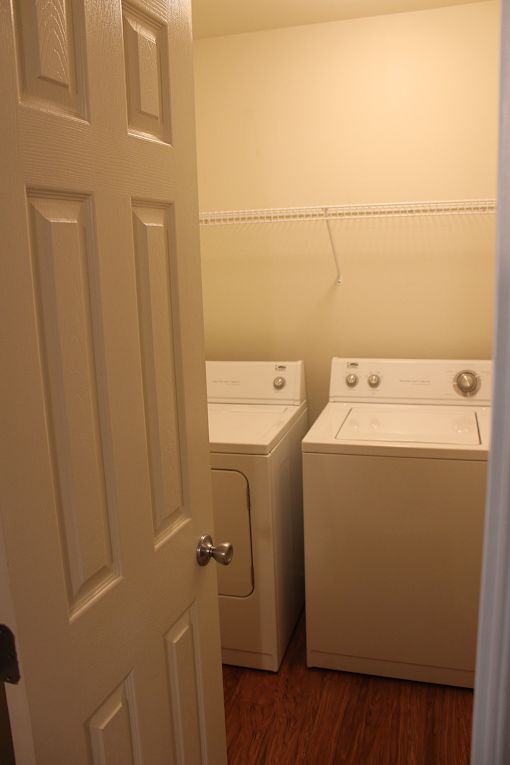 a door leading into a laundry room with two washing machines