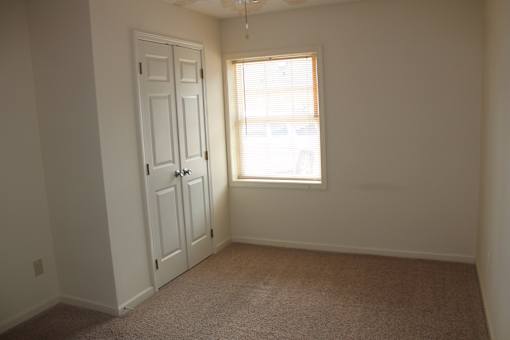 an empty room with a door and a window