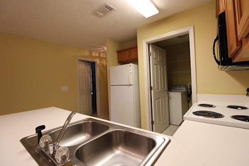 a kitchen with a sink and a stove and a refrigerator