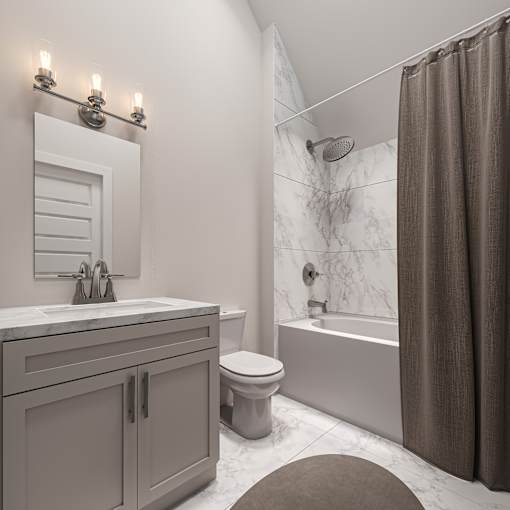 A bathroom with a toilet, sink, and shower.