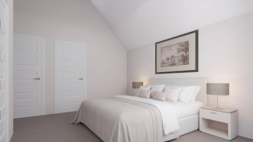 A white bedroom with a large bed and a framed picture on the wall.