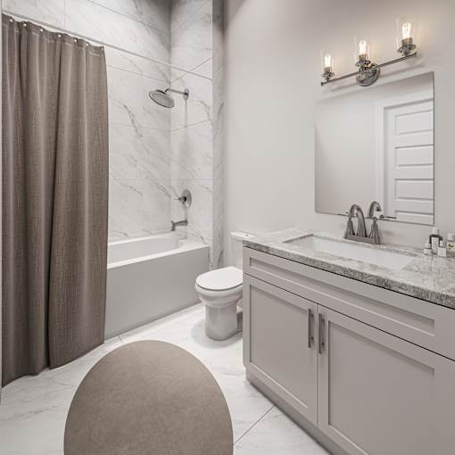 A bathroom with a toilet, sink, and shower.