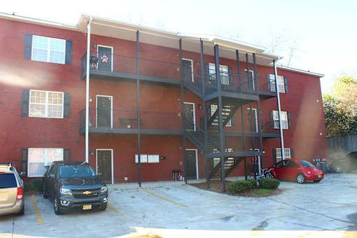 an apartment building with cars parked in front of it