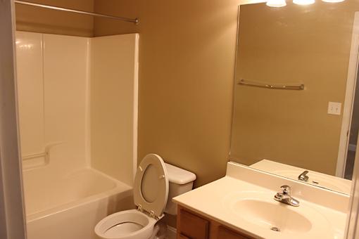 a bathroom with a toilet and a sink and a shower
