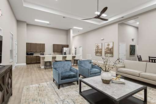 A living room with a blue chair and a coffee table.