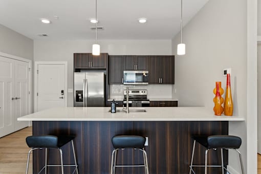 A modern kitchen with a bar stool.