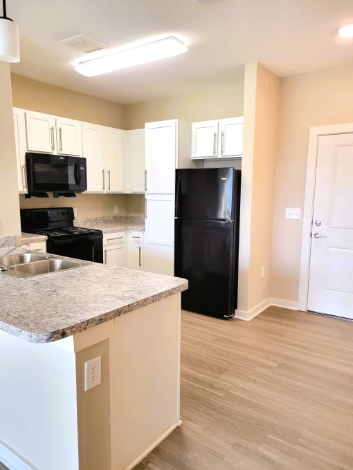 500 Northside Station Apartments Kitchen with Island, Refrigerator, Microwave, Oven