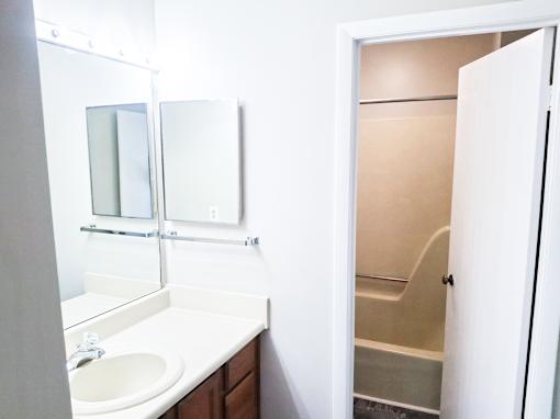 A white sink in a small bathroom.