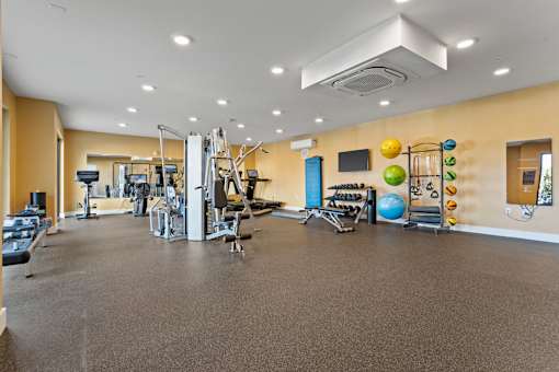 A spacious gym with a variety of exercise equipment.