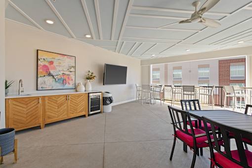 A room with a ceiling fan and a painting on the wall.