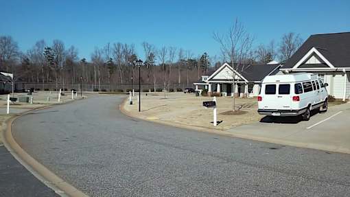 A white van is parked in a parking lot.