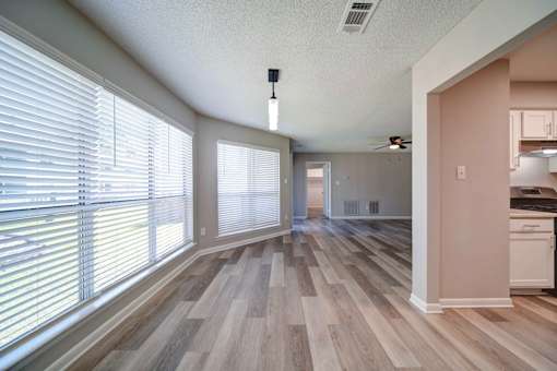 A room with wooden floors and a ceiling fan.