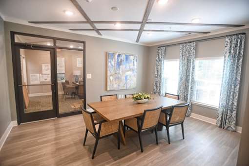 A dining room with a wooden table and chairs.