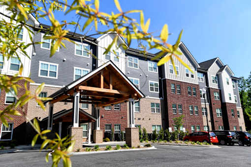 A large multi-story apartment building with a covered walkway.