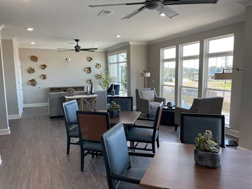 A dining room with a table and chairs.