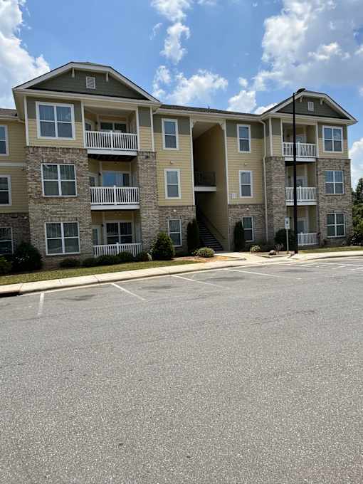 an apartment building with an empty parking lot