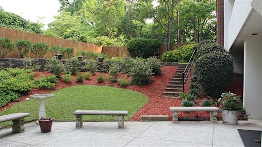 Croft House Elderly Apartments in Aiken, SC - Exterior, showing backyard with benches and grass
