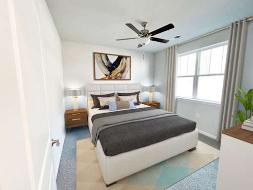 A bedroom with a large bed and a ceiling fan.