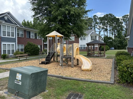 a playground in a park in front of some apartments
