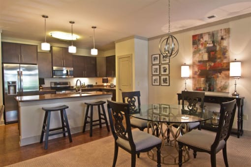 a dining room and kitchen with a table and chairs