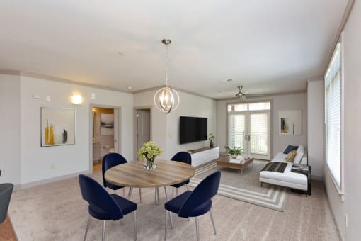 a living room with a table and chairs and a couch