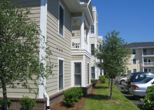 an apartment building with cars parked in front of it