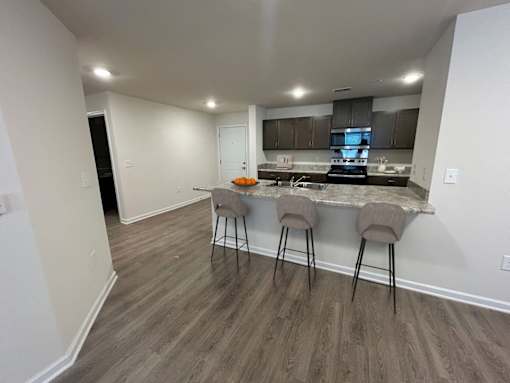 A kitchen with a bar stool and a countertop.