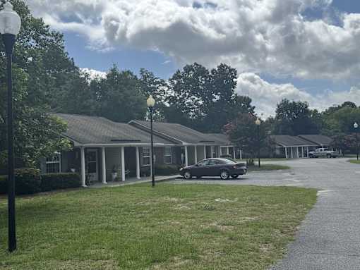 A black car is parked in front of a house.