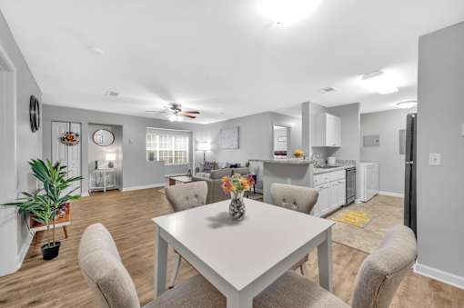 A modern kitchen with a dining table and chairs.