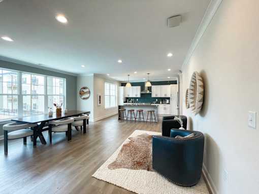 A modern living room with a dining table and a bar area.