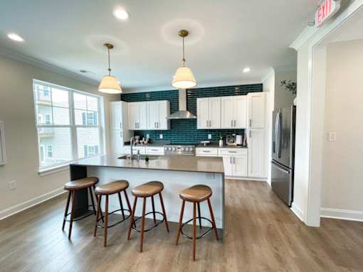 A kitchen with a bar area and a refrigerator.