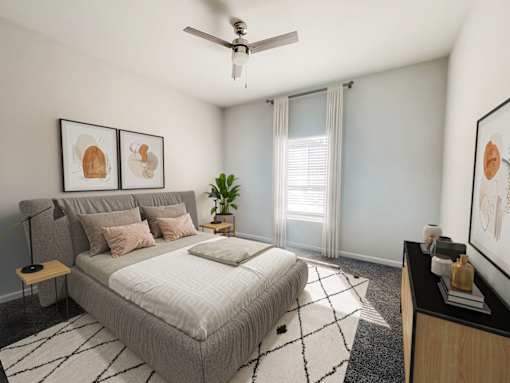 Taylors, SC Dog-Friendly Apartments - Northbrook - Bedroom with Plush Carpeting, a Ceiling Fan, and a Queen Sized Bed