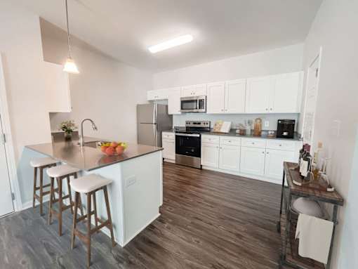 2-Bedroom Apartments in Taylors, SC - Northbrook - Kitchen with Stainless Steel Appliances, Modern White Cabinets, and a Breakfast Bar