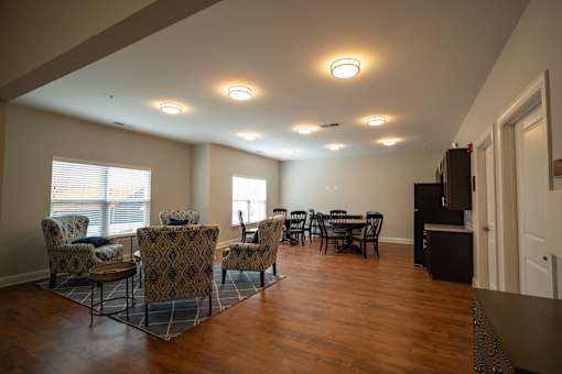 A living room with a dining table and chairs.