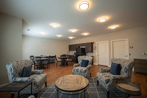 A living room with a patterned chair and a coffee table.