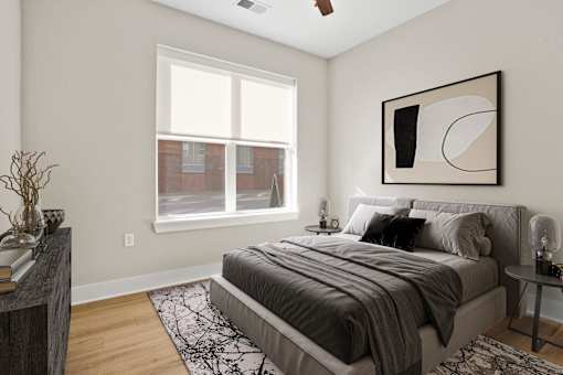 A bedroom with a large bed and a window.