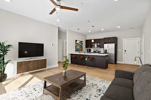 A living room with a flat screen TV and a wooden coffee table.