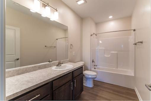 A modern bathroom with a white sink and a white toilet.